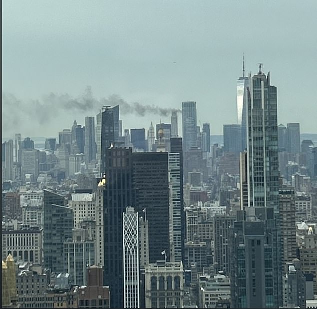 A Manhattan skyscraper still under construction has recorded a fire on its roof, filling the Financial District with smoke