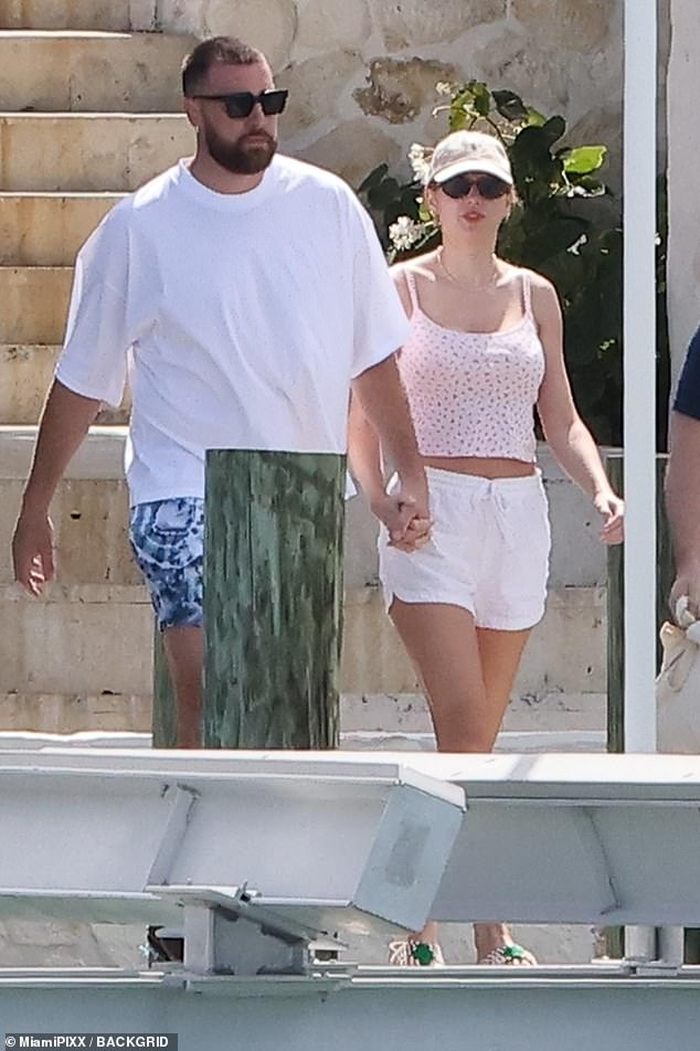 Taylor showed off her toned midriff in a pink and white crop top paired with white shorts that exposed her toned legs