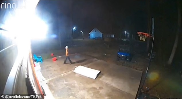 Video shows a man wearing a bright orange jacket walking to her home in Columbus County, North Carolina around 1 a.m.