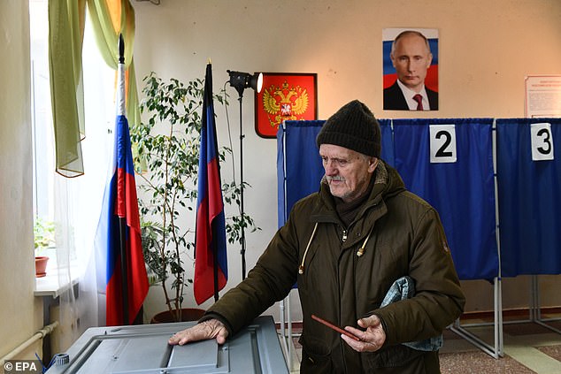 A man is seen casting his vote during the presidential election in Donetsk, a Russian-controlled part of Ukraine on March 17