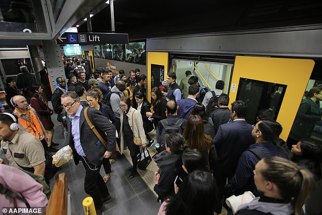 Record high immigration blamed for Australia's worst economic crisis in four decades (pictured at Sydney's Town Hall train station)