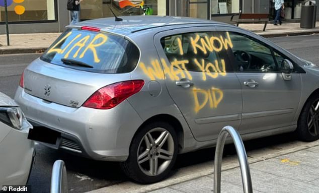 A photo of a wrecked car marked with the words 