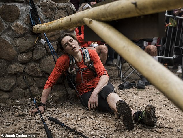 Photos show Paris slumped to the ground as she rested against a wall and looked exhausted after completing the race dubbed 'the race that eats its young'