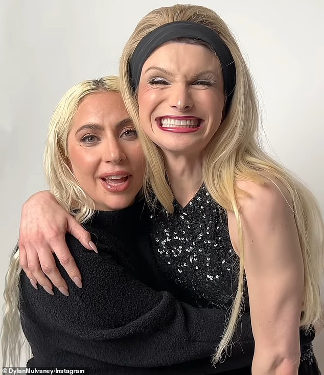 The pair posed for a photo shoot together, with the singer sitting on a wooden box wearing huge platform heels, while Mulvaney stood behind her.