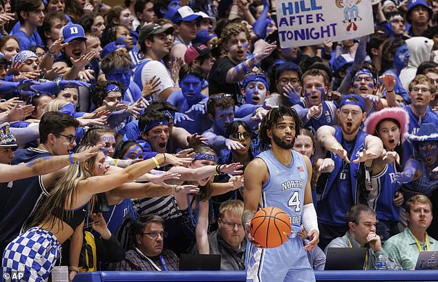 North Carolina's RJ Davis (4) inbounds the ball for the Duke student section