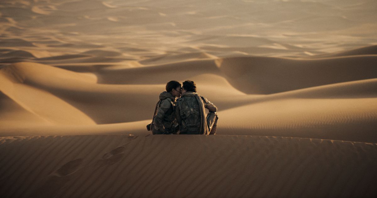Timothée Chalamet's Paul and Zendaya's Chani kiss at the top of a sand dune in Dune: Part Two.