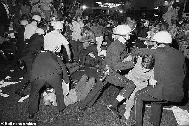 Nearly sixty years ago, delegates gathered at the International Amphitheater in the Windy City to nominate Hubert Humphrey for president, but outside it was chaos.  (Above) Police and protesters clash at the Conrad Hilton Hotel on Chicago's Michigan Avenue on August 28, 1968 during the Democratic National Convention