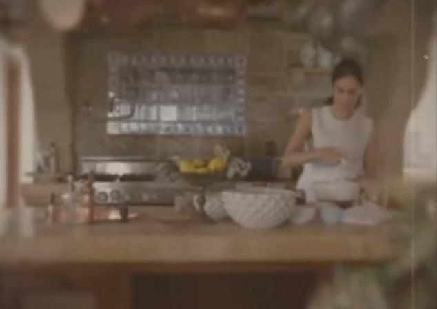 The brand's launch video shows Meghan cooking in a beautiful kitchen, holding copper pans above her head as she waves