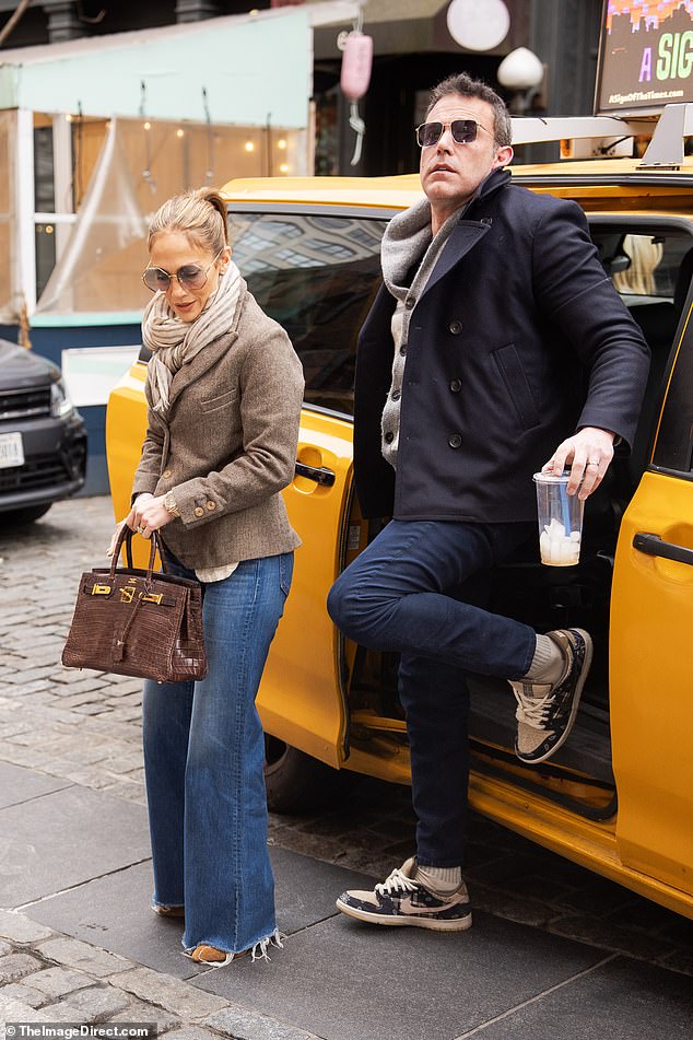 Dressed in a cardigan and jeans, Ben stayed close to Jennifer, who exuded movie star glamor in a simple ensemble with a wool jacket and faded denim