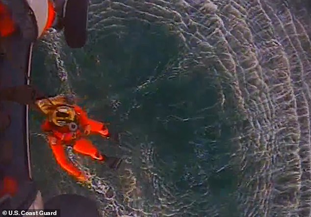 When rescuers spotted him, a man readied himself moments before lowering himself into the water to rescue Smelley 11 hours later.