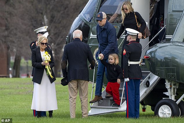 Baby Beau Biden held a small Easter egg in his hands as he exited the helicopter and was escorted by his grandparents