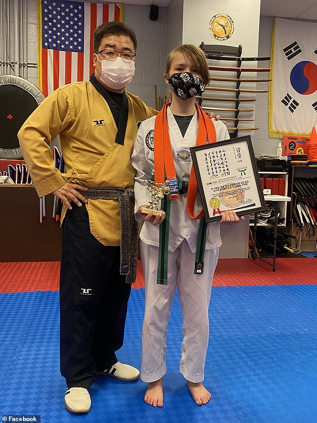 Gregg (right) receives a martial arts award