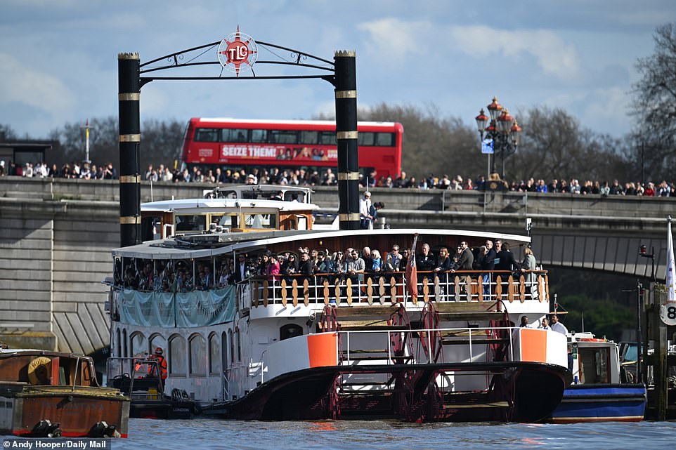 Barges full of spectators floated slowly down the river as crowds of people fixated on the drama on the water