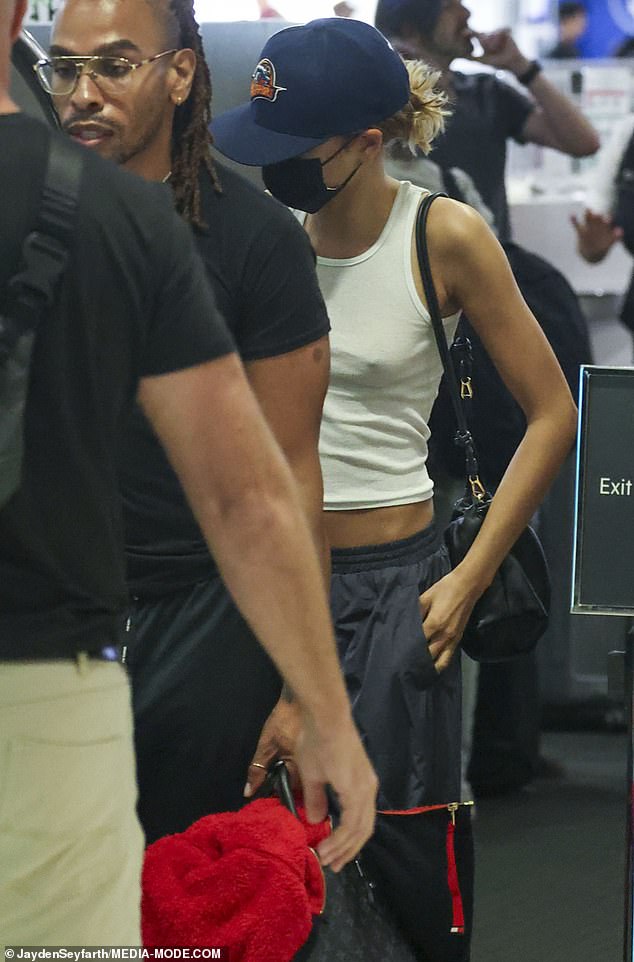 She put on a black face mask as she walked through the terminal