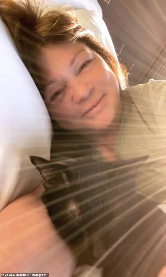 The cookbook author with one of her six cats at home in March