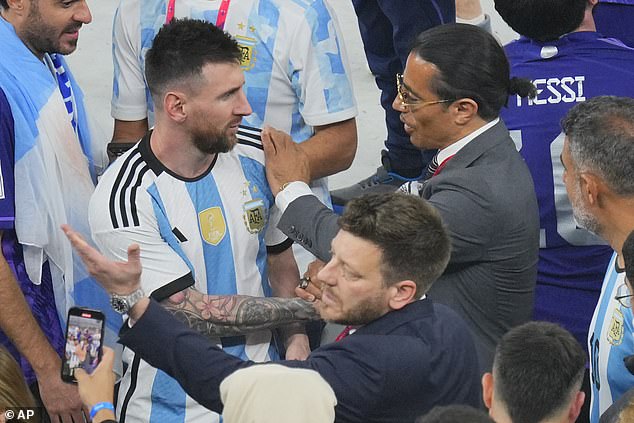 Salt Bae (right) places his hand on the shoulder of Argentina's Lionel Messi at the end of the World Cup final