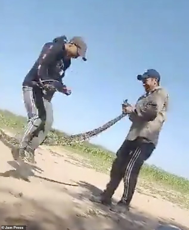 They began swinging the snake violently, allowing the third man to jump up and down as the snake's body passed underneath him