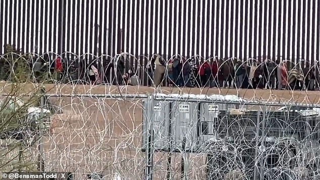 On Monday morning, the mostly Venezuelan migrants lined up at the border wall to turn themselves into border agents after passing through barbed wire fences.