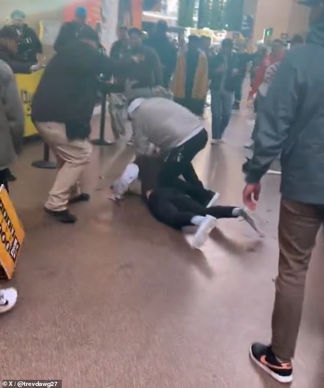 In a third brawl, a man punched another man while putting his knee on his back