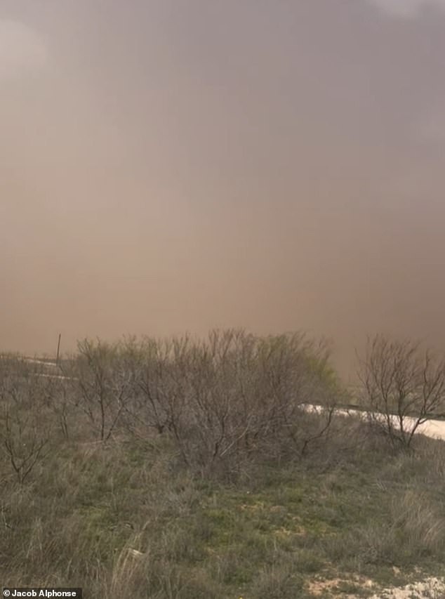 In Texas, a raging dust storm took over the land, turning the sky an ominous shade of red and gray, with only a few white clouds visible in the distance