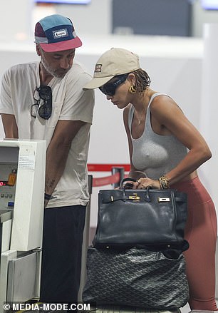 Taika showed off a pair of white Reebok sneakers and opted for a maroon and blue cap