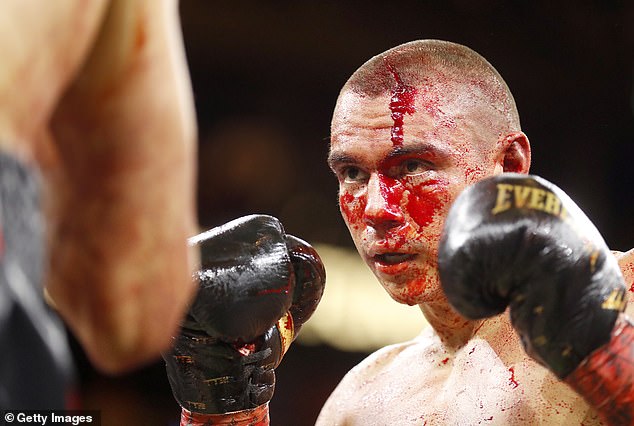 The Australian was blinded by his own blood after suffering a massive gash to the top of his head in the second round of the fight (pictured)