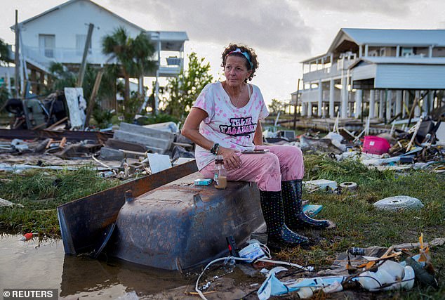 Jewell Baggett, 51, sits on a bathtub amid the wreckage of her home in Horseshoe Beach, Florida, which Hurricane Idalia reduced to rubble in August 2023