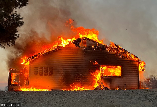 A view shows a house burning as the Fairview Fire near Hemet, California, US, September 5, 2022. Wildfires have driven up costs for insurers - who have increased premiums
