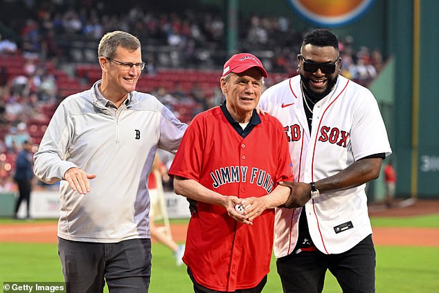 The former CEO is pictured with current president Sam Kennedy (L) and former player David Ortiz (R) after a pre-game ceremony at Fenway Park in August 2023