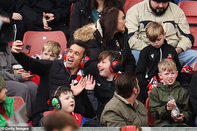 Co-owner Rob McElhenney sits in the autism-friendly quiet zone with young fans in August