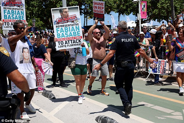 People block the road to express their anger toward Florida State House Representative Fabian Basabe (R) as he participates in the 15th annual Miami Beach Pride Celebration parade on April 16, 2023 in Miami Beach