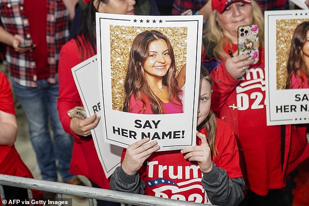 Trump supporters hold signs with an image of 22-year-old Laken Riley during the ex-president's rally in Rome, Georgia on March 8.  Riley became the face of immigration reform after she was illegally killed by a suspected immigrant in the US in February