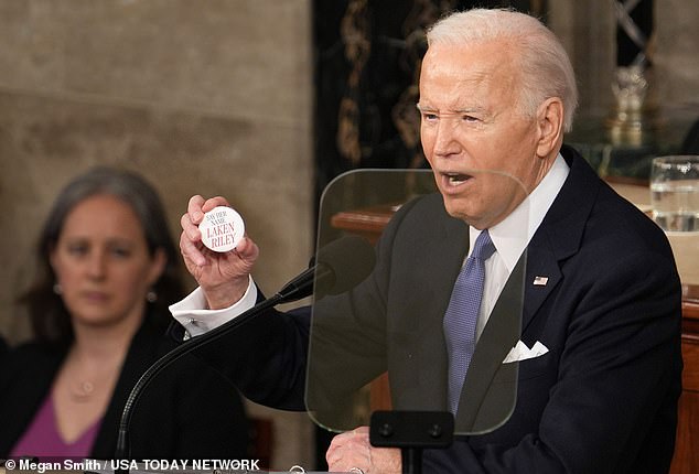 Biden holds a button in memory of Laken Riley during his State of the Union address in March