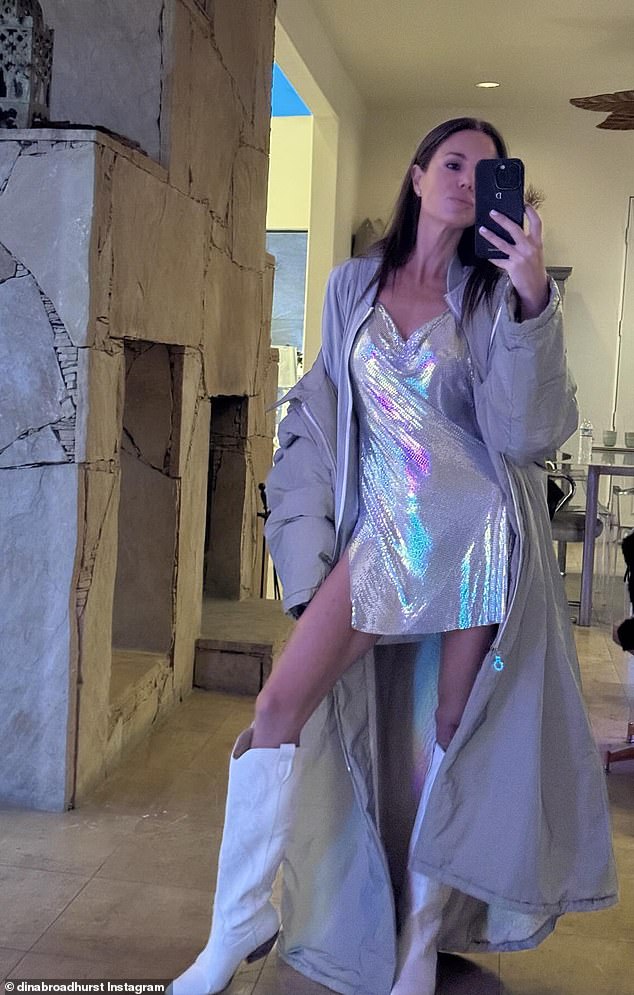 For the occasion, Dina wore a festival-chic style in a shimmering silver mini dress, which she paired with a gray quilted jacket and knee-high white cowboy boots