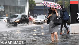 A woman almost drowned after being swept into a storm drain amid wild weather that hit Victoria - while no one could hear her scream for help over the rushing water (stock image from wild weather in Melbourne)