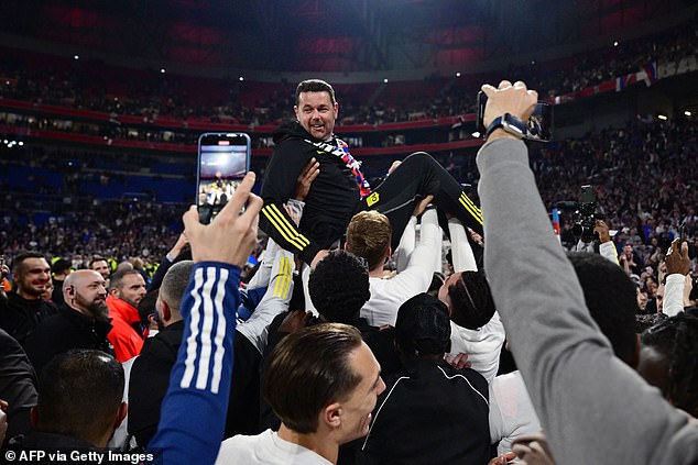 Manager Pierre Sage was hoisted into the air by his players as Lyon celebrated their victory