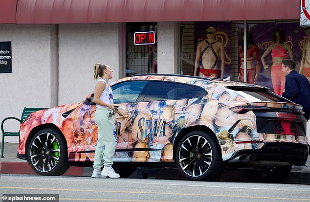 She loaded up the backseat of her custom Lamborghini as she laughed with her friend before the two headed to their next destination