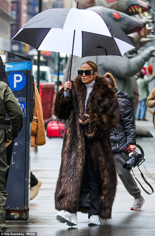 Jennifer, 54, looked glamorous in a brown fur coat as she braved the rainy weather in New York