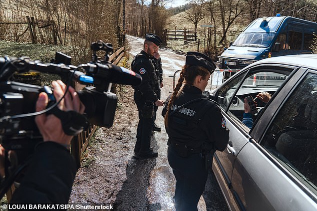A French gendarme stands on the road to the small village of Le Haut-Vernet in the French Southern Alps, in Le Vernet on April 1, 2024