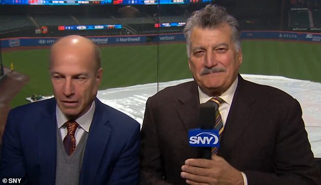 Cohen's expression disappears the moment he thinks he's off camera during Tuesday's rain delay