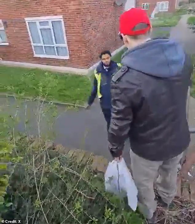 The father's anger reaches a peak at this point and he pushes the driver with both hands.  Escaping any further conflict, the bus driver steps off the edge, puts his hands in his pockets and stares down at the irate father.