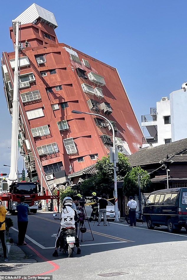 This photo taken by Taiwan's Central News Agency (CNA) on April 3, 2024 shows people looking at a damaged building in Hualien