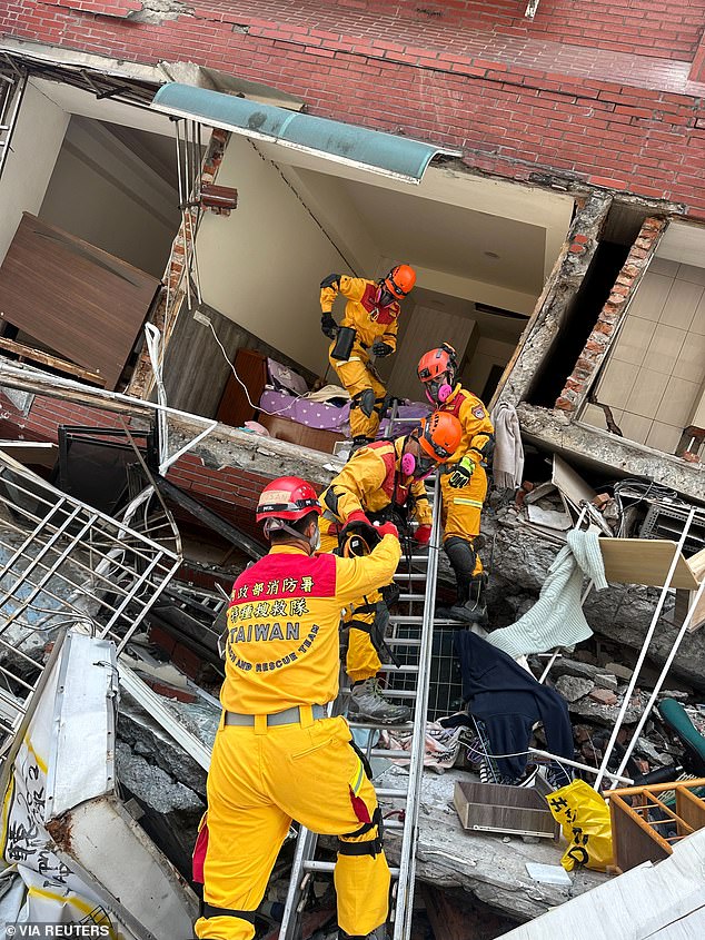 Firefighters work at the site of a building collapse after the earthquake in Hualien, Taiwan