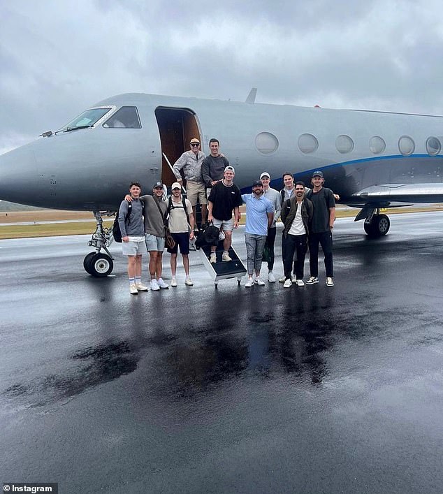 Lions players pose in front of the private jet they used in the US, with board member Cathie Reid's partner Stuart Giles pictured left, on the top row of the stairs