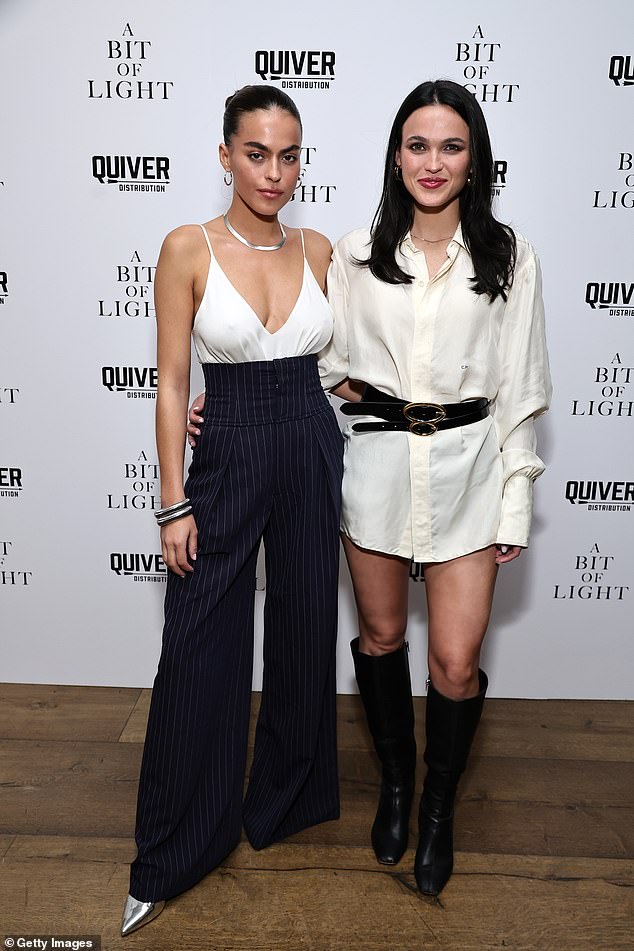 Models – and sisters – Sarah and Mary Nader stunned with their contrasting looks.  Sarah wore a busty, plunging white top without a bra and cool black pinstripe trousers with a high waist and flared legs.  Mary looked cool in a loose white shirt dress with knee-high black boots