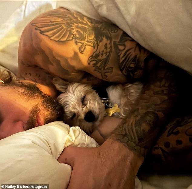 The 27-year-old Rhode founder also posted a shirtless photo of her husband Justin Bieber sleeping in bed with one of their two white Yorkshire Terriers