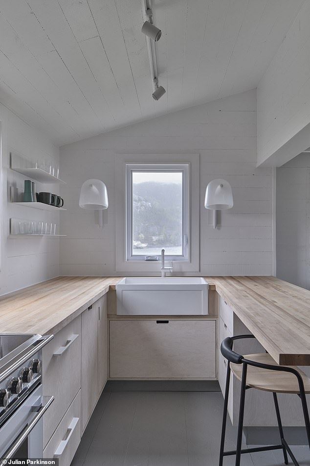 The main floor of the Dunn House has an entrance hall, living room, TV room, a galley-style kitchen, laundry room and laundry room.