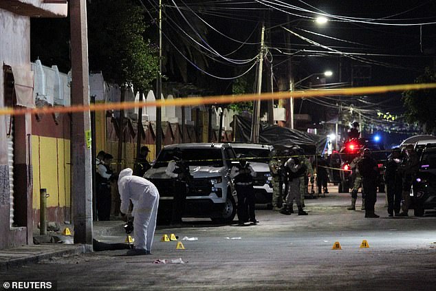 A forensic technician works at a site where Celaya's mayoral candidate for the ruling Morena party, Gisela Gaytán, was shot dead on Tuesday