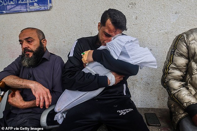 More than 30,000 Palestinians have been killed in Israeli airstrikes since the October 7 Hamas attack that killed 1,200 people.  Photo: A Palestinian father holds one of his children who was killed in a drone strike