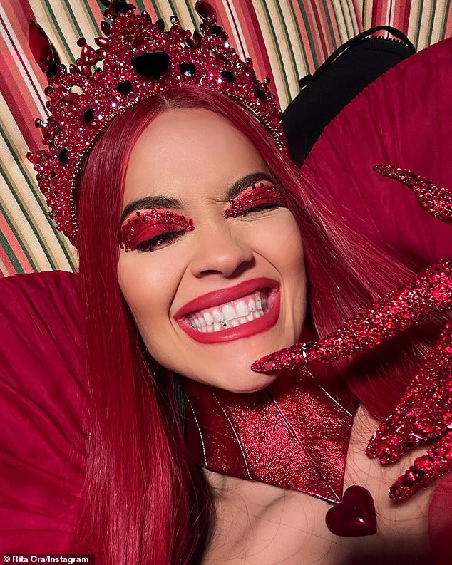 Rita wore red mascara, a long straight red wig and a glittering crown covered in costume jewels.  She let her hair down and showed off a playful grin in some of her Instagram photos